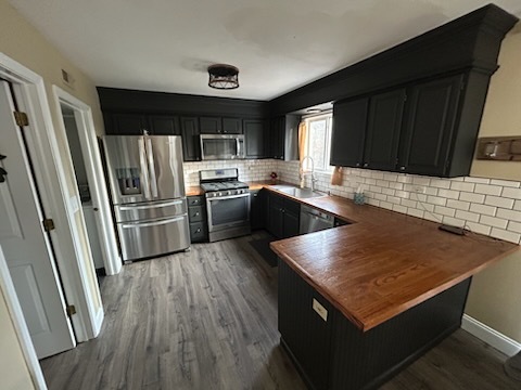 29 Ivanhoe Lane Cary, IL 60013 - Photo 15 of 36 a kitchen with stainless steel appliances granite countertop a refrigerator a sink dishwasher a stove and white countertops with wooden floor