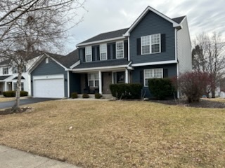 29 Ivanhoe Lane Cary, IL 60013 - Photo 3 of 36 a front view of a house with a yard and garage