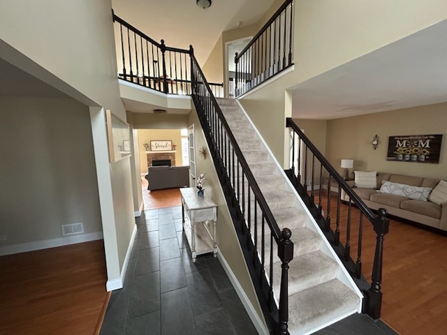 29 Ivanhoe Lane Cary, IL 60013 - Photo 4 of 36 a view of staircase with lots of frames and wooden floor