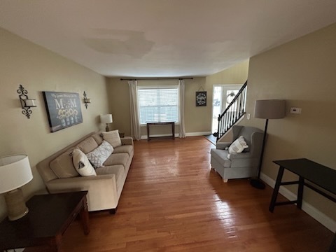 29 Ivanhoe Lane Cary, IL 60013 - Photo 6 of 36 a living room with couches and a potted plant on table with wooden floor