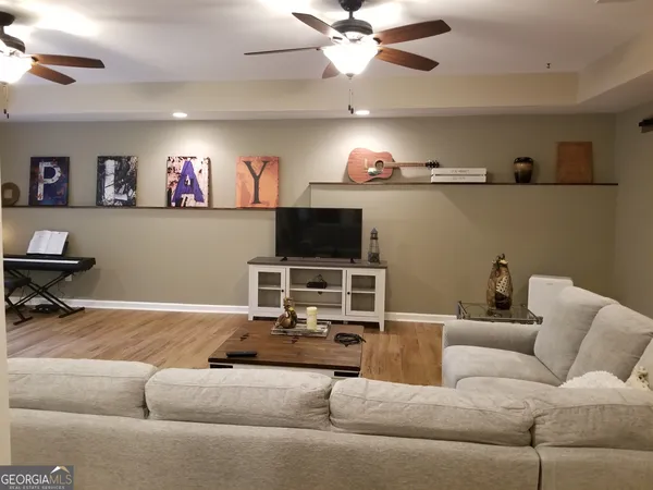 a living room with furniture and a flat screen tv