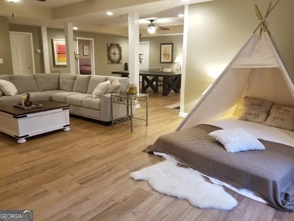 a living room with furniture and wooden floor