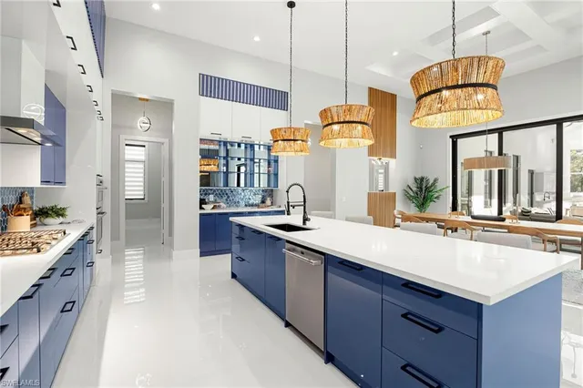 a large kitchen with a large counter top appliances and cabinets