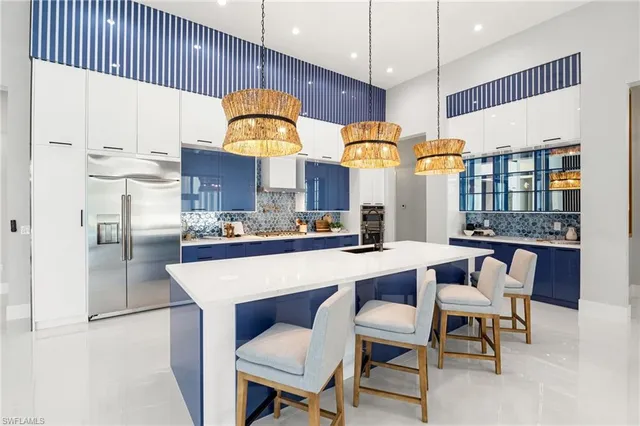 a large kitchen with a table and chairs