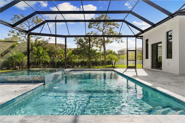 a swimming pool with trees in the background