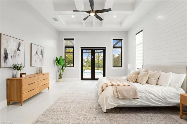 a bedroom with a large bed and a chandelier