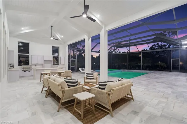 a living room with patio furniture and a yard