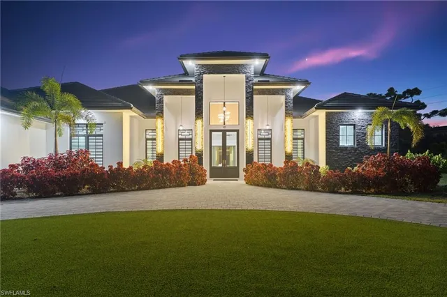 a front view of a house with a garden