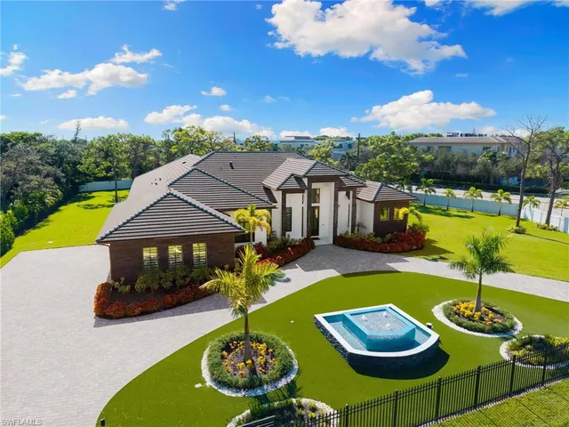 a view of a house with swimming pool and furniture