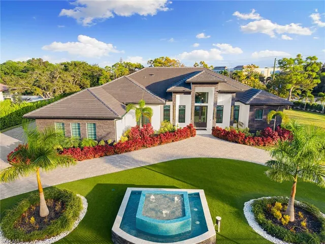 a front view of a house with a yard table and chairs