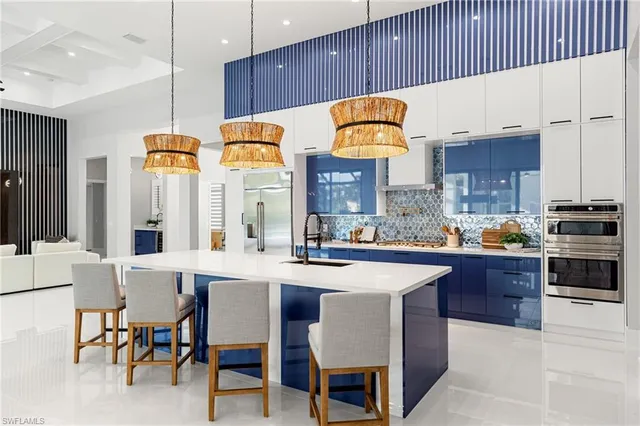 a kitchen with cabinets a counter and chairs