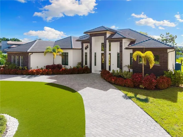 a front view of a house with swimming pool yard and outdoor seating