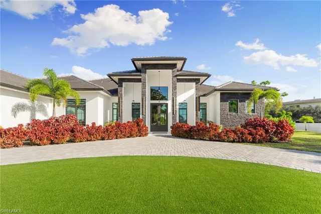 a front view of a house with a garden