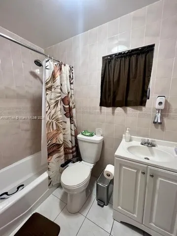 a bathroom with a toilet sink and shower