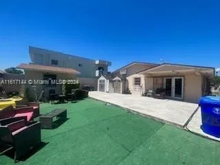 a view of a house with a yard porch and sitting area