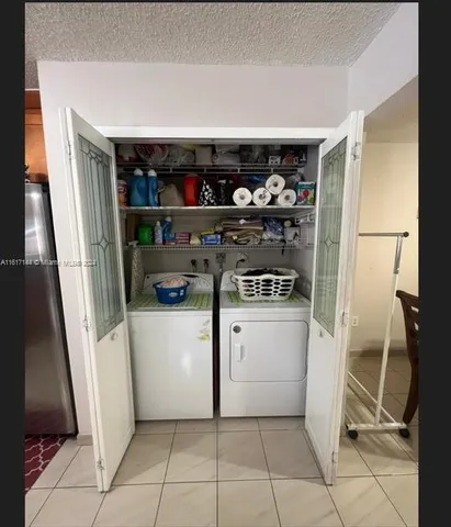 a kitchen with a stove and white cabinets