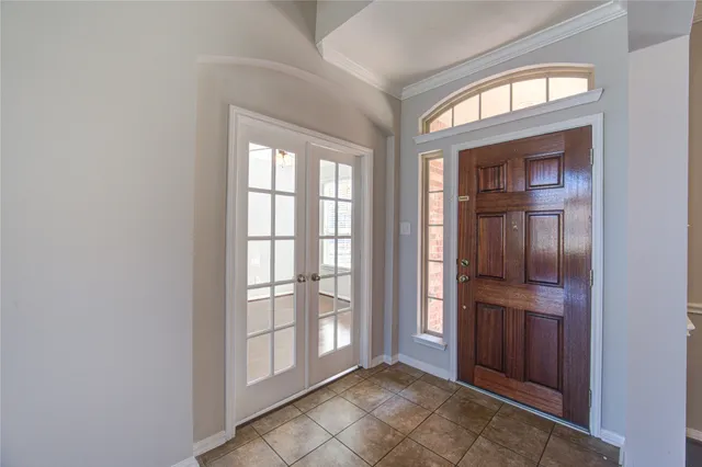 an empty room with entrance and windows