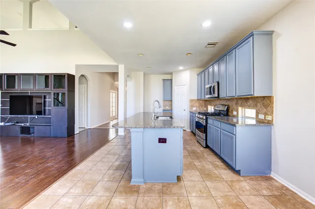 a large kitchen with stainless steel appliances lots of counter top space