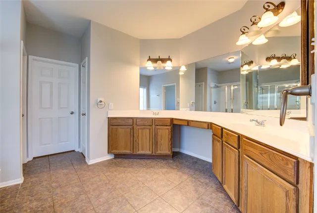 a large kitchen with kitchen island a sink stainless steel appliances and cabinets