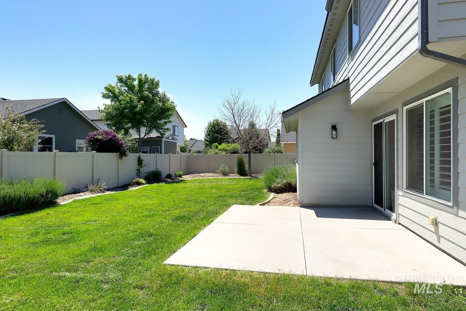 846 North Hidden View Way Star, ID 83669 - Photo 46 of 49 Expansive backyard featuring a manicured lawn, a concrete patio, and a durable vinyl privacy fence