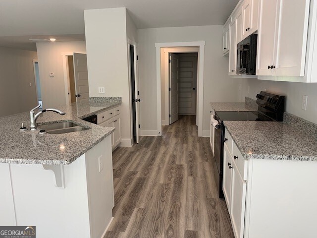 465 Riley Circle Northwest Milledgeville, GA 31061 - Photo 3 of 9 a kitchen with granite countertop a sink and cabinets