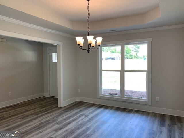 465 Riley Circle Northwest Milledgeville, GA 31061 - Photo 4 of 9 a view of a room with wooden floor chandelier and a window