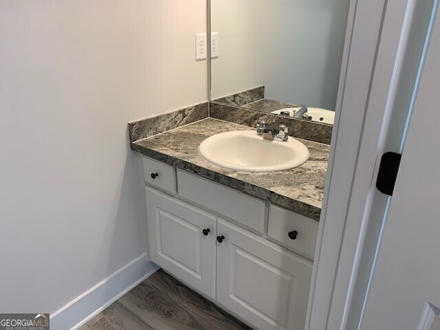 465 Riley Circle Northwest Milledgeville, GA 31061 - Photo 7 of 9 a bathroom with a granite countertop sink and a mirror