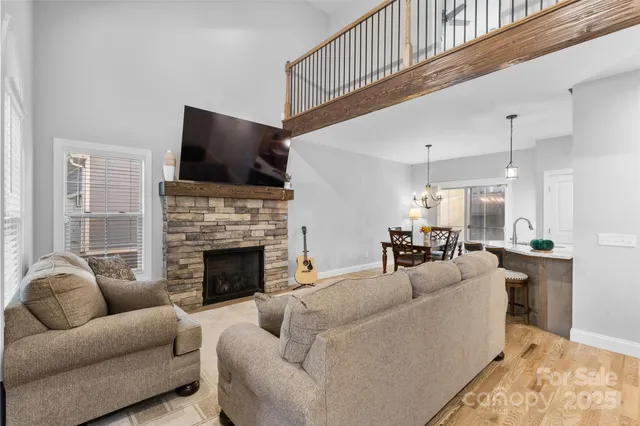 a living room with furniture fireplace and flat screen tv