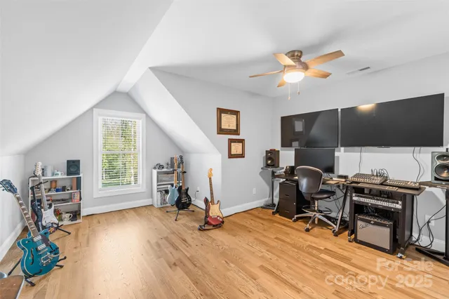 a view of a workspace with furniture and a ceiling fan