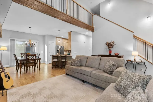a living room with furniture and a dining table