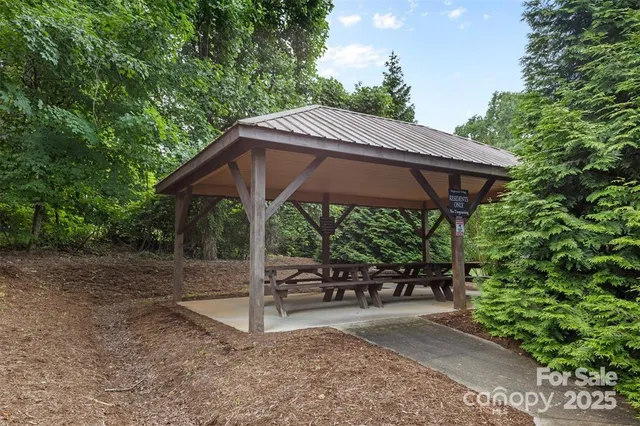 a view of a park with a tree in the background