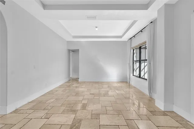 a large kitchen with stainless steel appliances lots of white cabinets