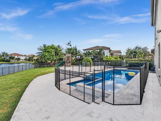 a view of a livingroom with a chandelier furniture and a ceiling fan