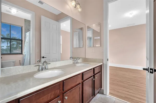 a bathroom with a sink double vanity and a mirror