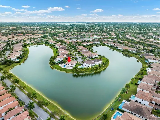 an aerial view of a house with a yard basket ball court and outdoor seating