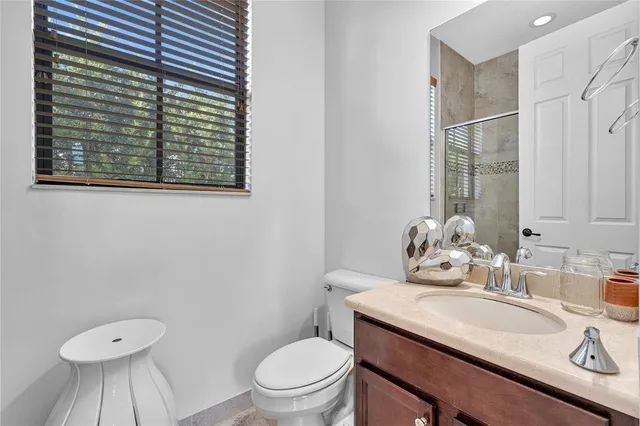 a view of an empty room with window and chandelier