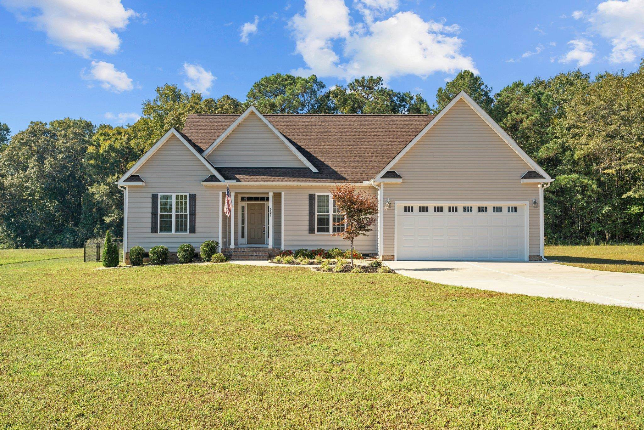 a front view of a house with a yard and garage