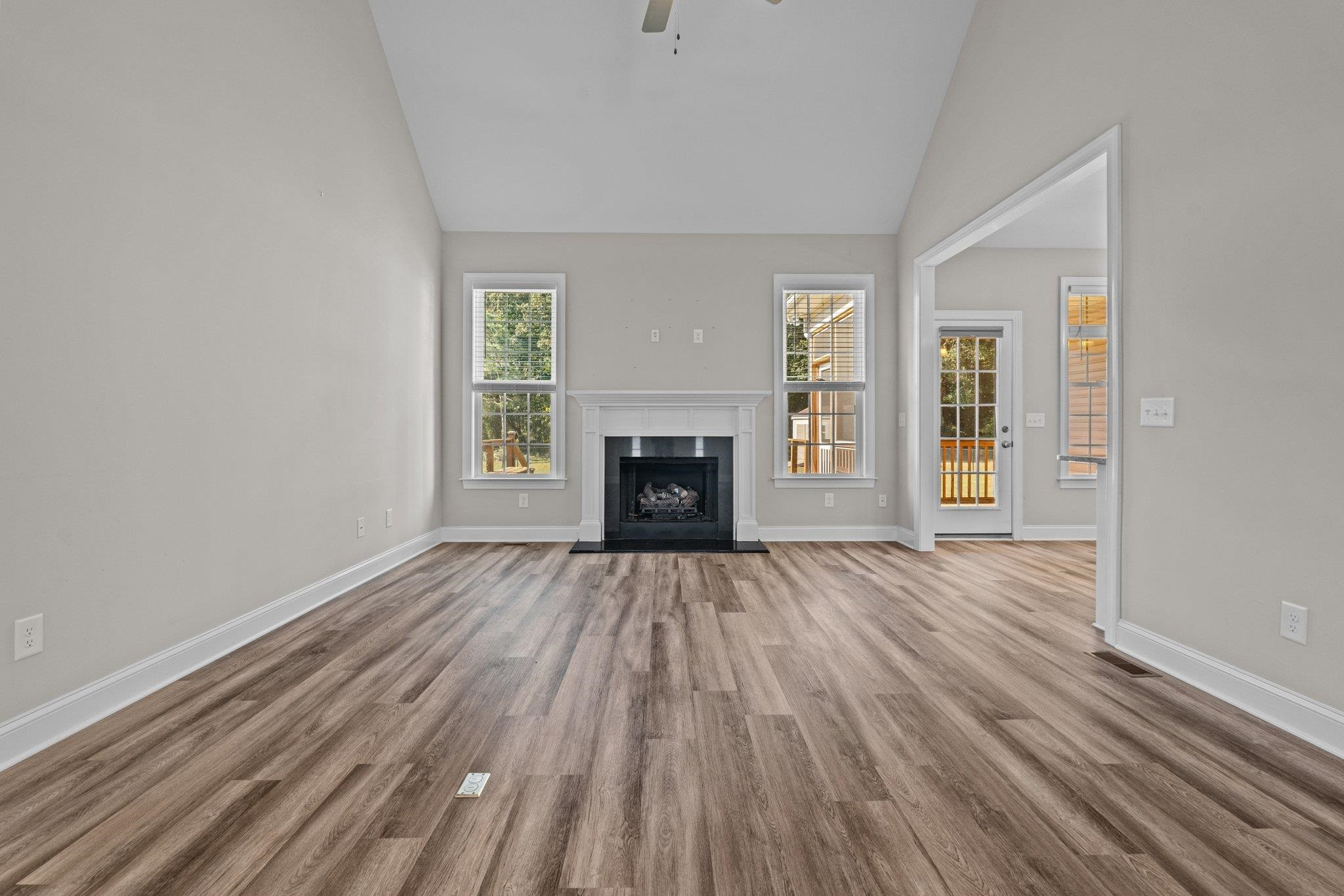 991 Sheriff Johnson Road Lillington, NC 27546 - Photo 13 of 52 a view of an empty room with wooden floor fireplace and a window