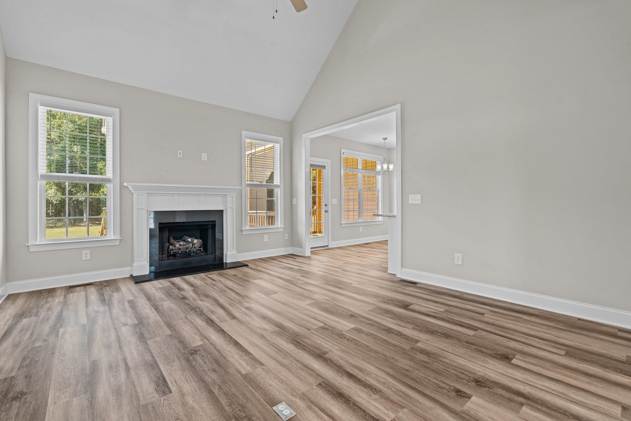 991 Sheriff Johnson Road Lillington, NC 27546 - Photo 14 of 52 a view of empty room with wooden floor and fireplace