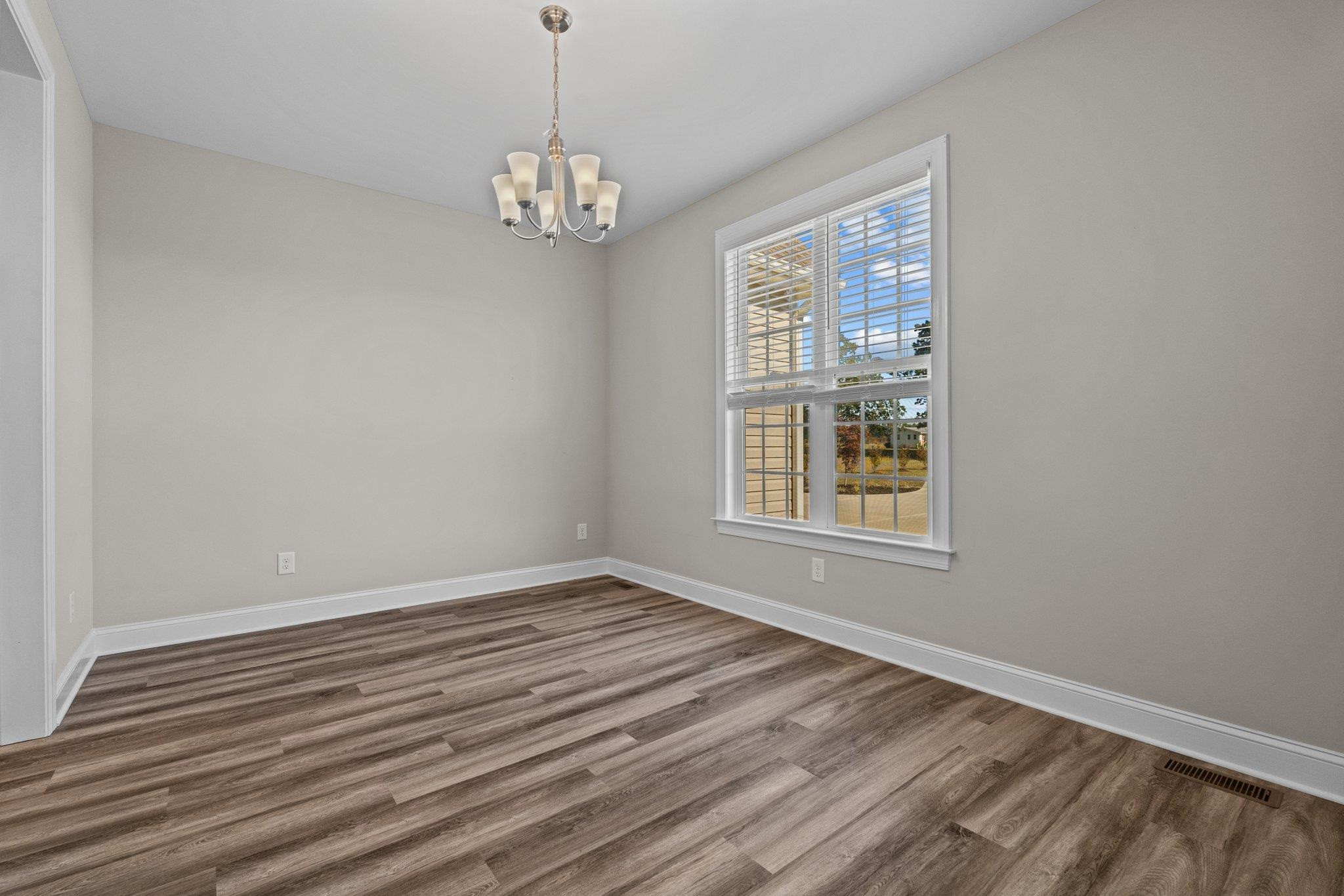 991 Sheriff Johnson Road Lillington, NC 27546 - Photo 24 of 52 a view of an empty room with wooden floor and a window