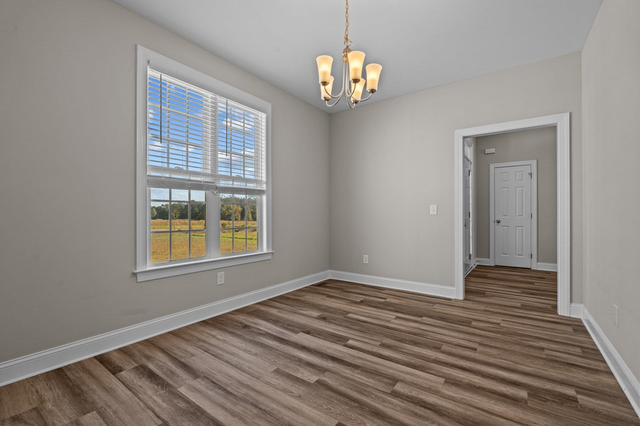 991 Sheriff Johnson Road Lillington, NC 27546 - Photo 25 of 52 a view of an empty room with wooden floor and a window