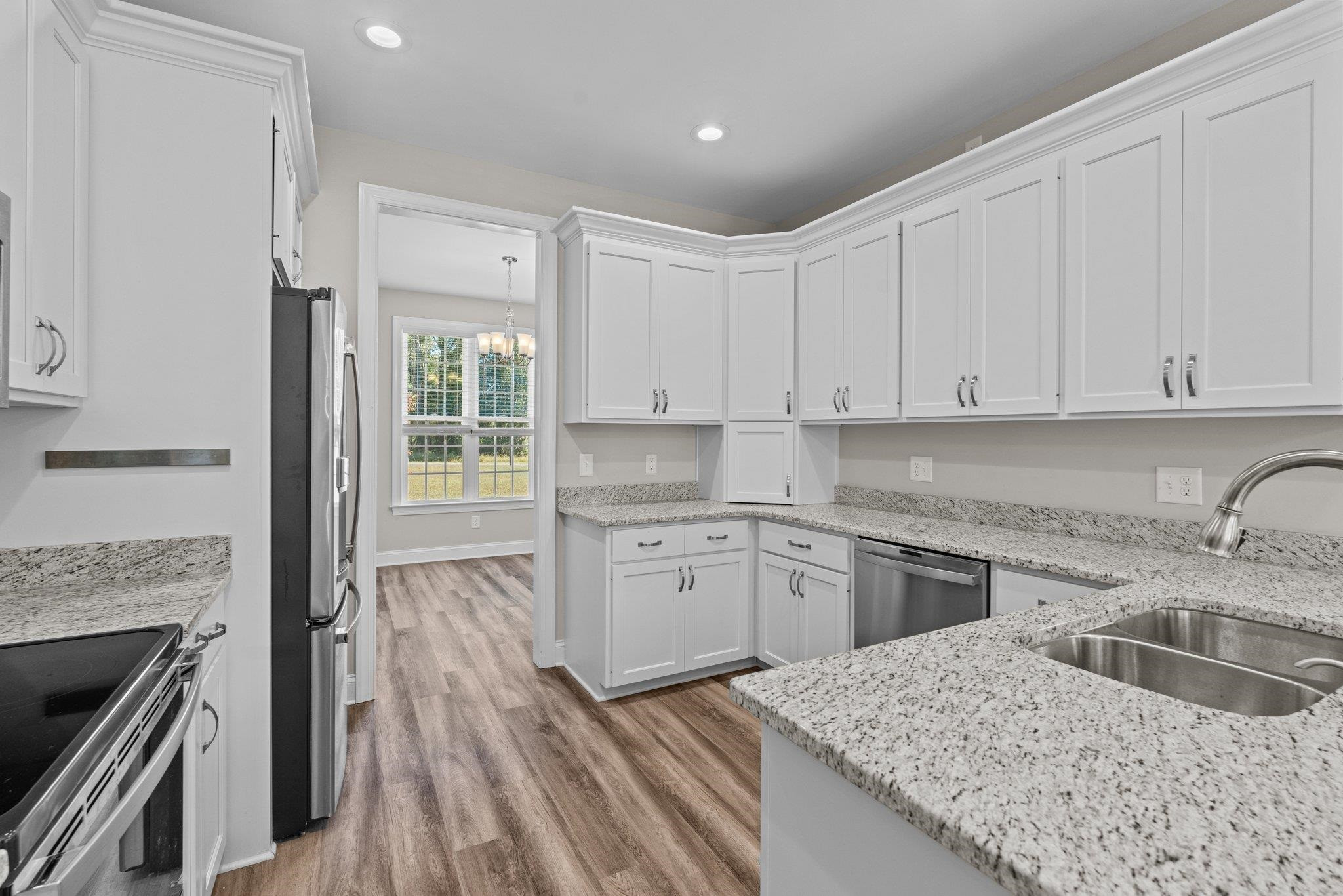991 Sheriff Johnson Road Lillington, NC 27546 - Photo 28 of 52 a kitchen with granite countertop a sink stainless steel appliances and cabinets