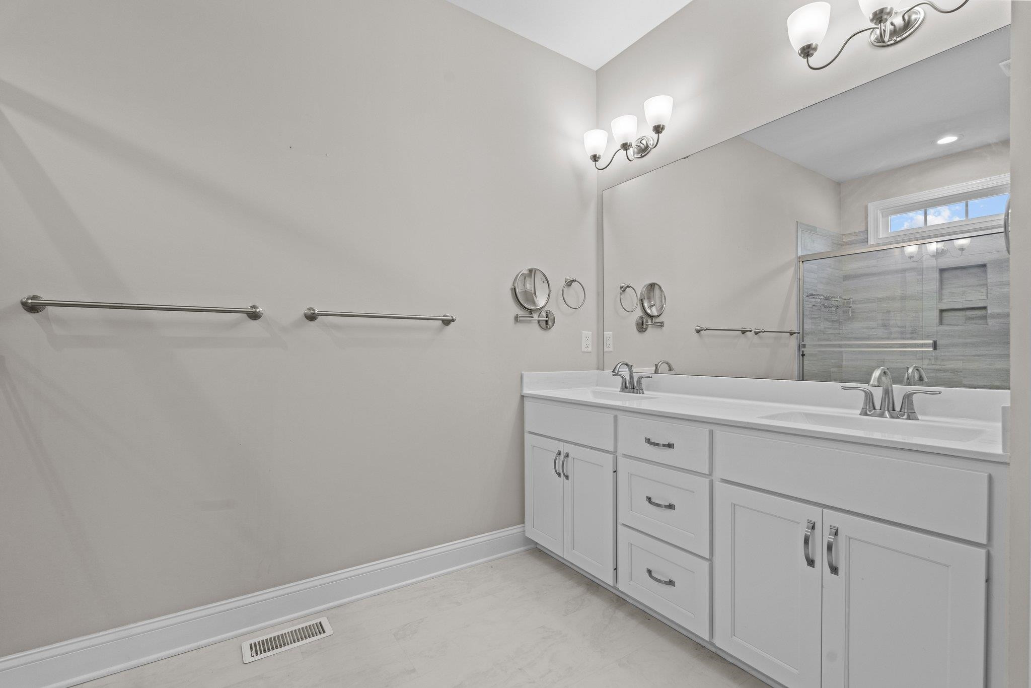 991 Sheriff Johnson Road Lillington, NC 27546 - Photo 35 of 52 a bathroom with a double vanity sink and a mirror