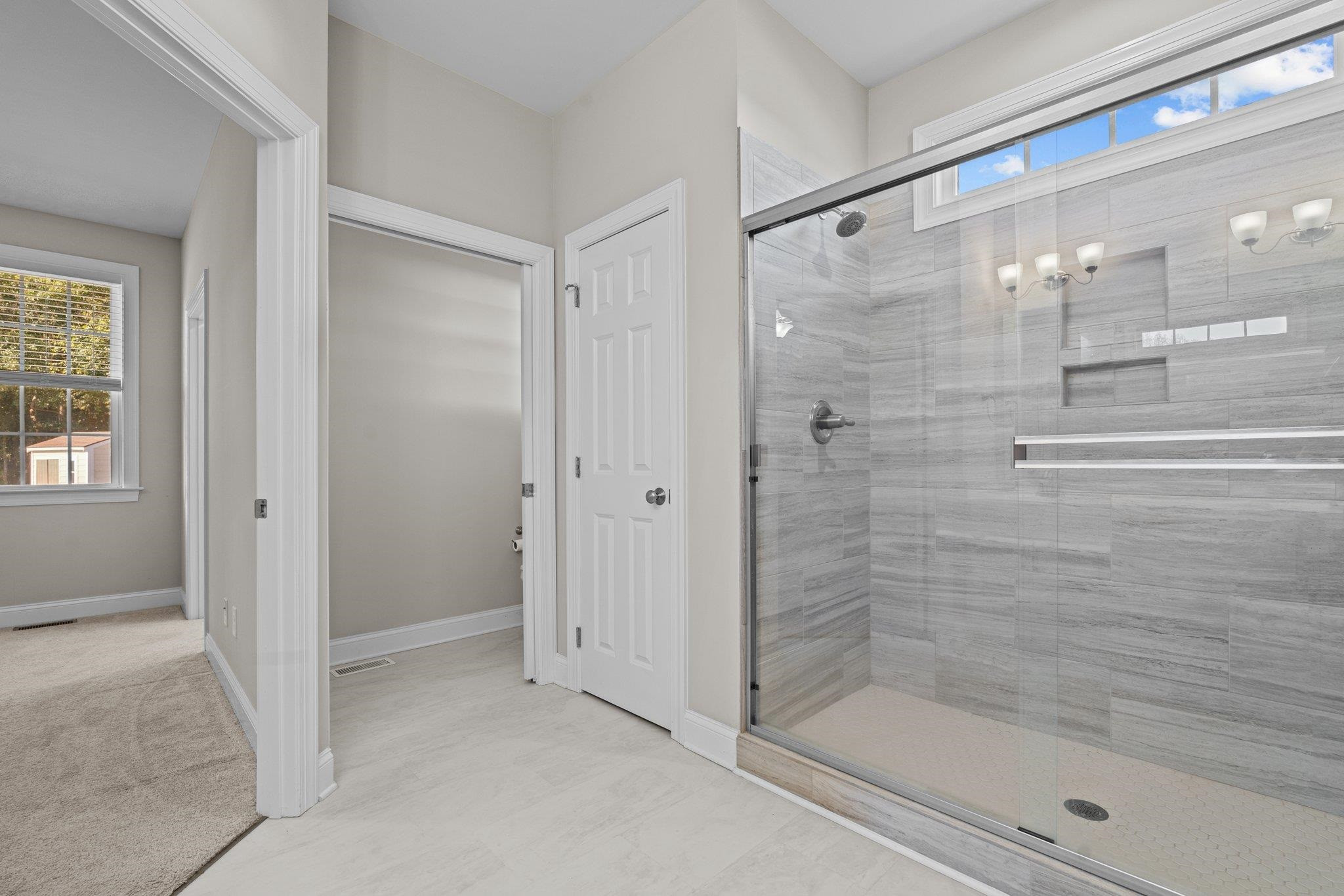 991 Sheriff Johnson Road Lillington, NC 27546 - Photo 36 of 52 a bathroom with a glass shower door