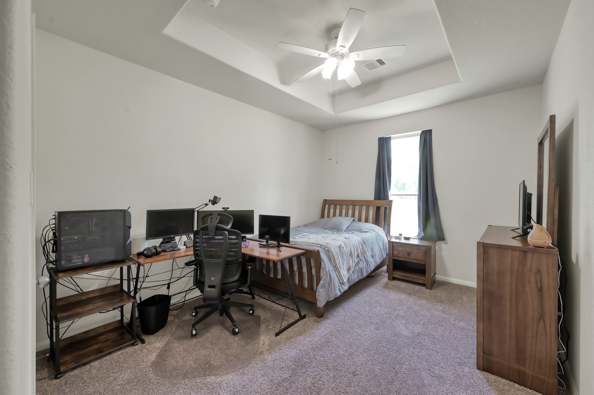 6264 Rolling Hills Road Conroe, TX 77303 - Photo 18 of 24 a spacious bedroom with a bed a desk and chair