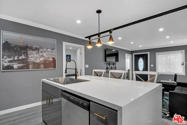 a bedroom with a bed and a tv on the dresser