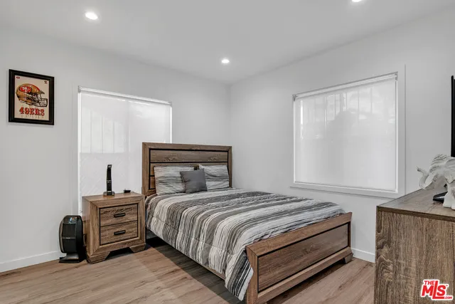 a bedroom with a bed and a television