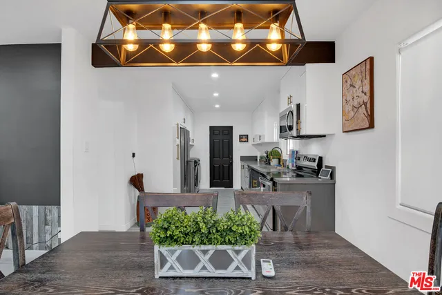 a kitchen with lots of counter top space and wooden floor
