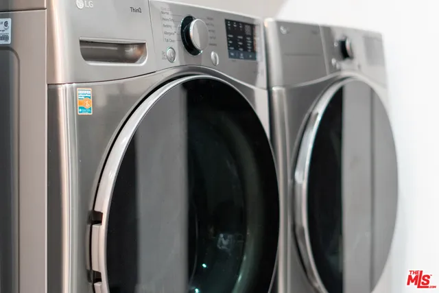 a bathroom with a sink vanity mirror and toilet