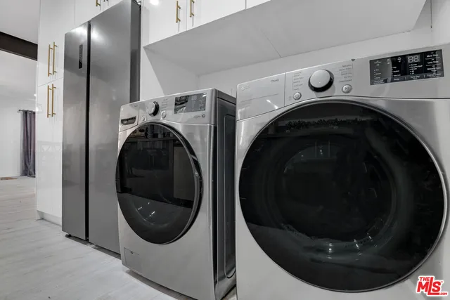 a living room with furniture and a painting on the wall